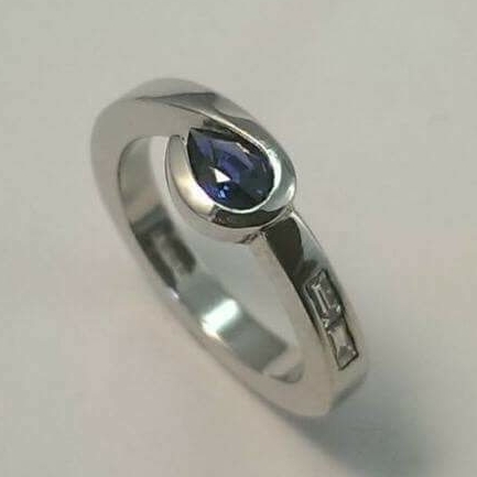 create own engagement ring : Package C: Heavy forged platinum shank cradling a pear shape sapphire with bagguette diamond shoulders